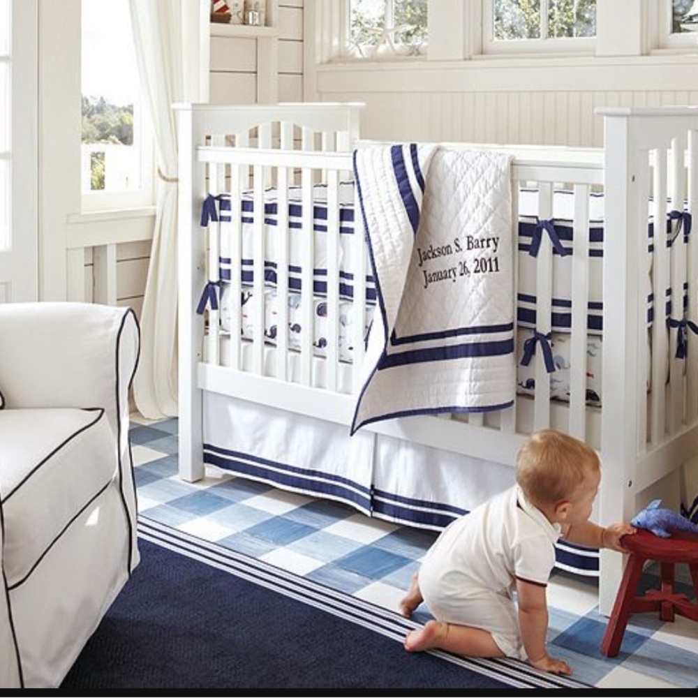 New Pottery Barn crib skirt with navy stripes.